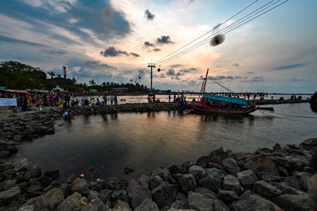 Indonesians enjoy the sunset at Jakarta Bay. Photo: AFP