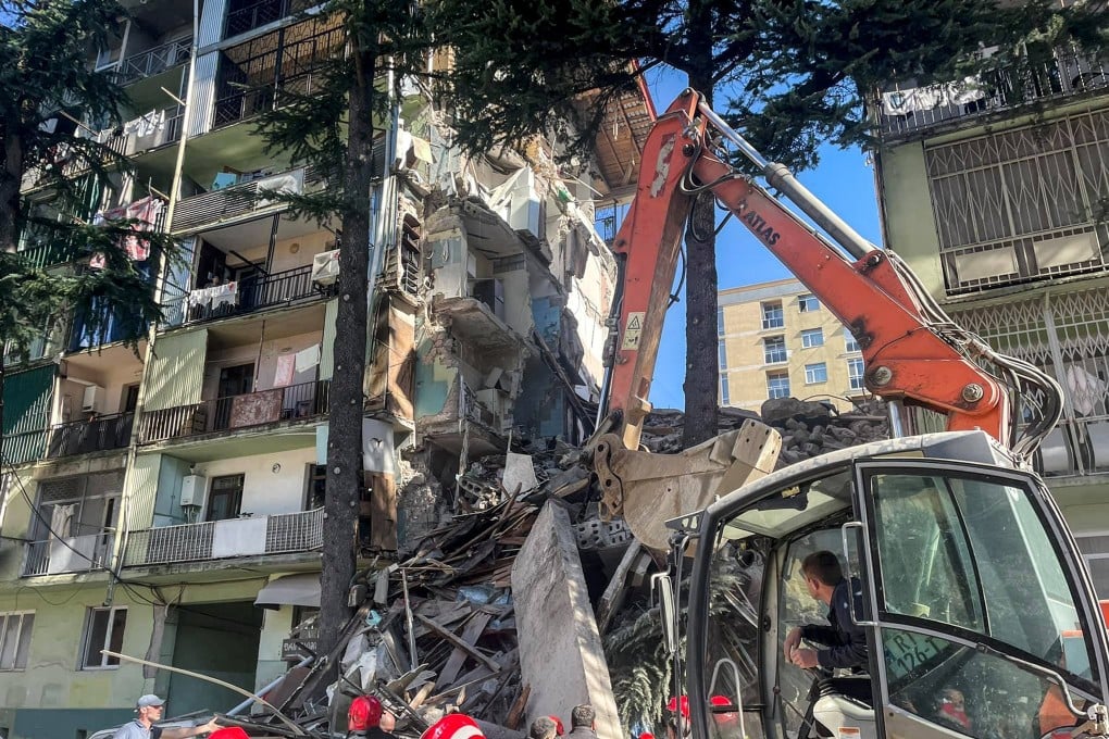 Rescuers work on the ruins of a collapsed building in Batumi, Georgia on Saturday. Photo: ajaratv.ge via AP