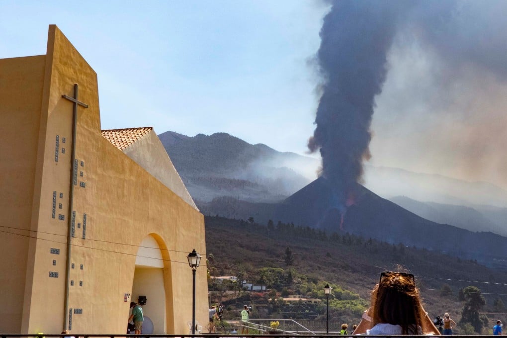 A woman looks at the Cumbre Vieja volcano in eruption in La Palma, Canary Islands, Spain on Saturday. Photo: EPA-EFE