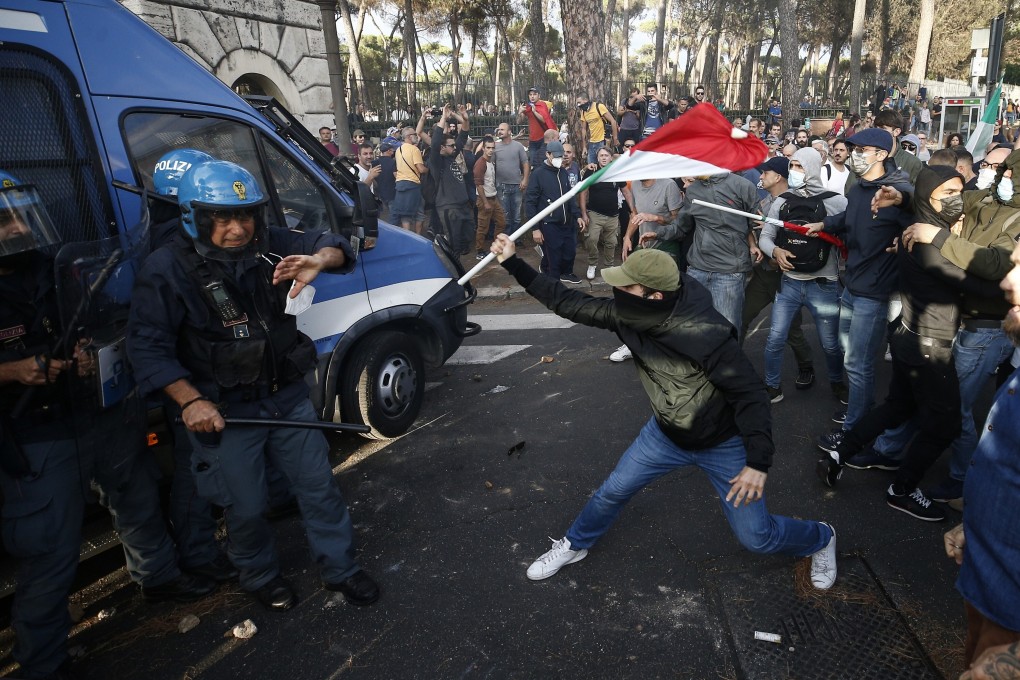 Police clash with demonstrators during a protest against the Covid-19 health pass in Rome, Italy on Saturday. Photo: LaPresse via AP