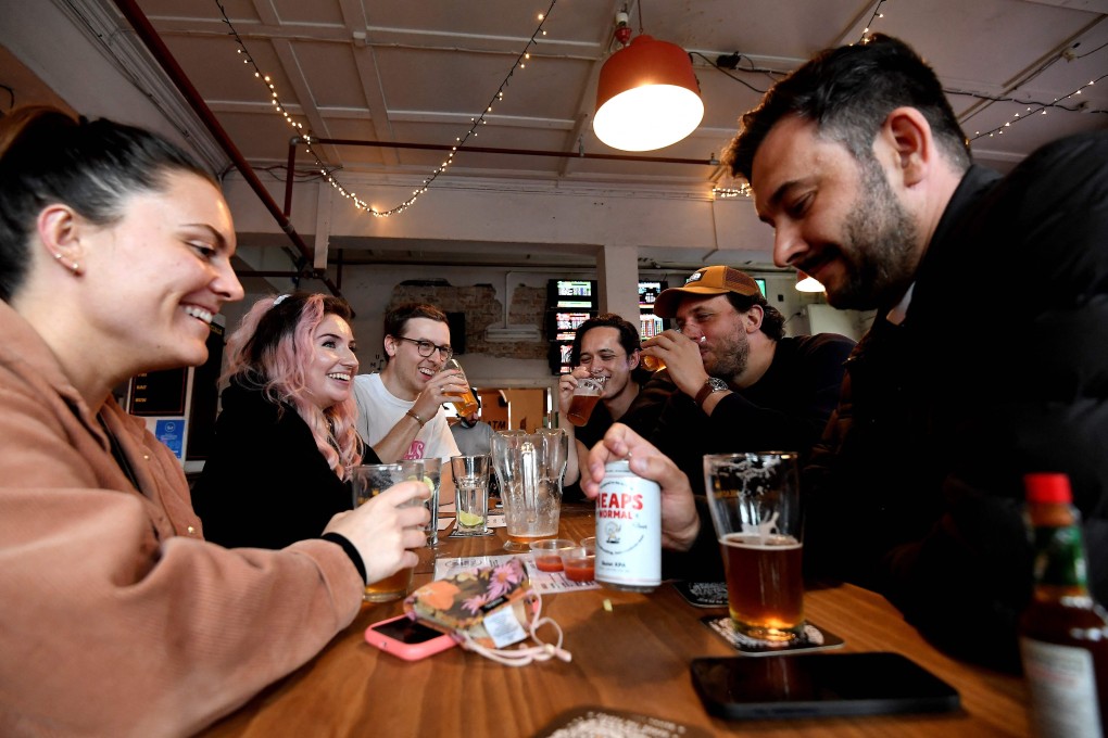 People enjoy drinks at a pub in Sydney. Photo: AFP