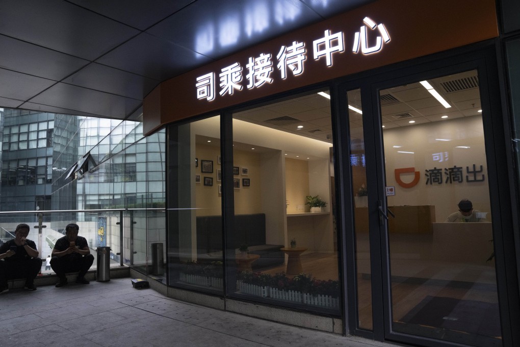 Men wait outside a center for drivers of Didi, a ride hailing platform that employs millions of drivers who are part of China's growing gig economy, near the headquarters in Beijing on July 16, 2021. Photo: AP