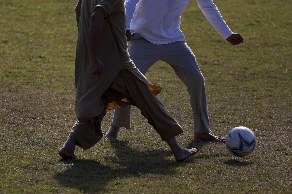 Afghan refugees play a game of football in Jincheon on October 13, 2021. Photo: AP