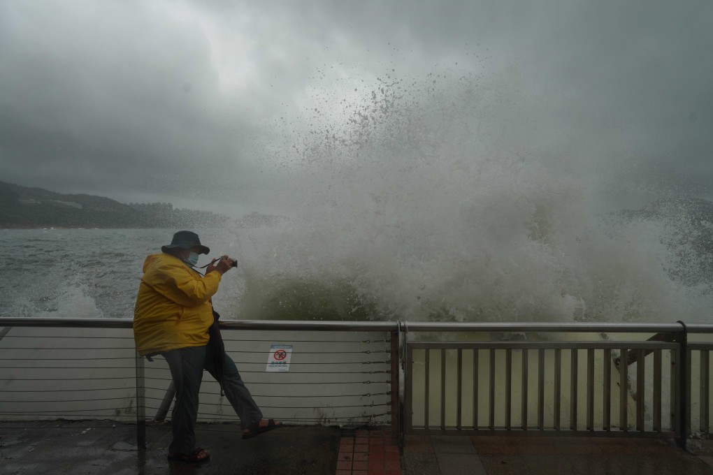 A Hong Kong man takes photos along the waterfront in Heng Fa Chuen amid Typhoon Kompasu. Photo: Winson Wong