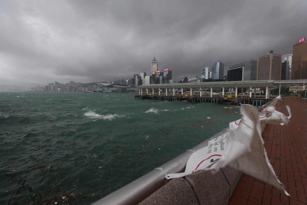 Winds whip government warnings placed along the water’s edge on Wednesday. Photo: Nora Tam