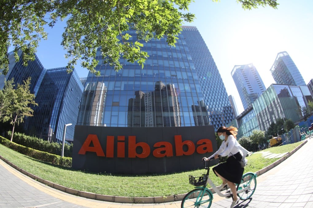 A woman rides past an Alibaba office building in Beijing, China, on August 26, 2021. Photo: Simon Song
