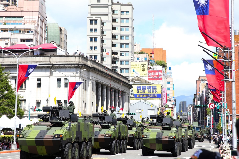 Military tanks pass in front of the Presidential Office during the National Day celebration in Taipei. Photo: Bloomberg