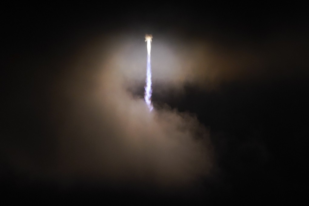 A rocket carrying the Lucy spacecraft soars through a cloud as it lifts off from Florida, US, on Saturday. Lucy will observe Trojan asteroids that orbit the sun in front of and behind Jupiter. Photo: AP