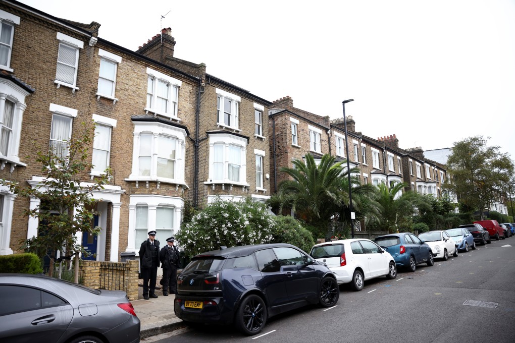 Police stand guard outside a house believed to be an address belonging the suspect. Photo: Reuters