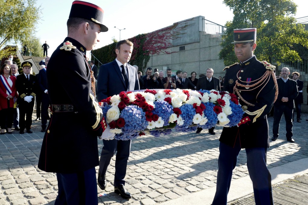 French President Emmanuel Macron lays a wreath near the Pont de Bezons, Bezons bridge, during a ceremony commemorating the 60th anniversary of the October 17, 1961 deadly repression of a demonstration of Algerians in Paris. Photo: Reuters