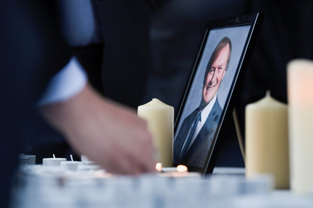 People light candles during a vigil for British MP David Amess, who was stabbed to death on Friday. Photo: Reuters