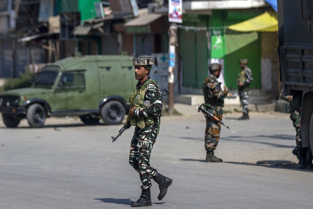 Indian paramilitary soldiers stand guard on a road south of Srinagar, Indian-administered Kashmir, on Saturday. Photo: AP
