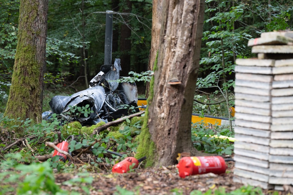Debris from a crashed Robinson R44 helicopter lies in a forest near the border with Hesse and Bavaria in Germany. Three people where killed in the accident. Photo: DPA