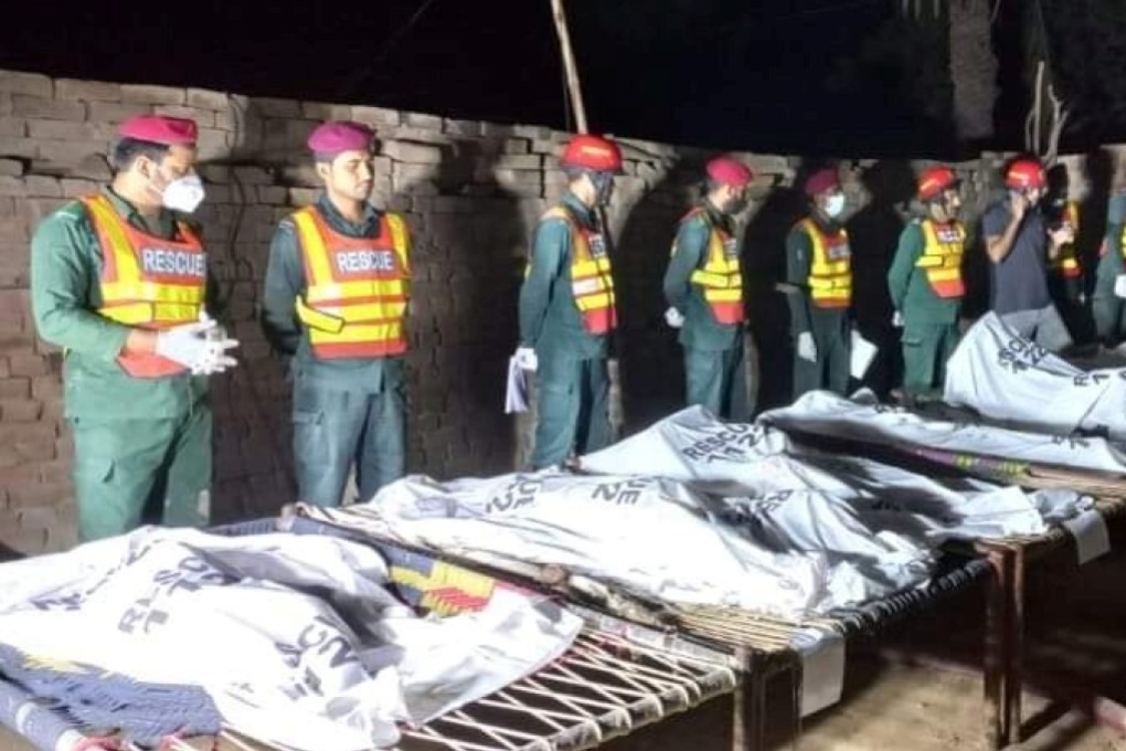 Emergency services personnel gather near the bodies of victims who police say were burned alive in Muzaffargarh, Pakistan, on Sunday. Photo: Punjab Emergency Service (Rescue 1122) Handout via Reuters