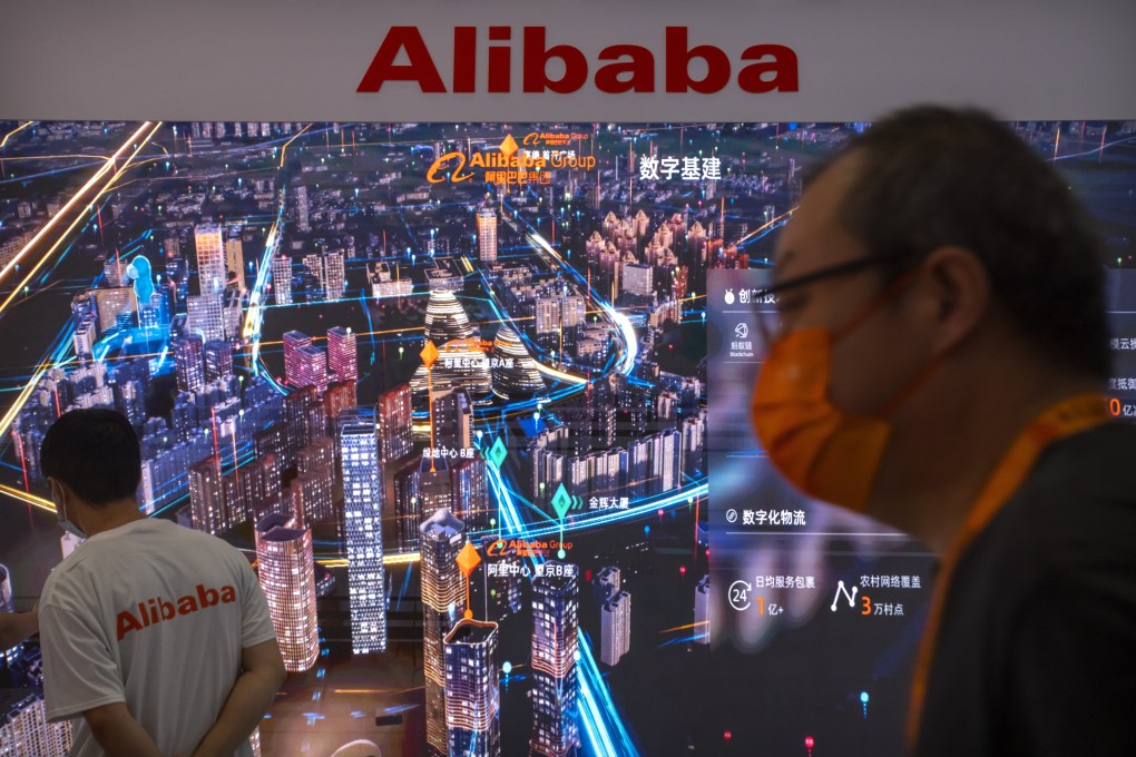 Visitors and staff members walk past an electronic display at a booth for Chinese technology firm Alibaba at the China International Fair for Trade in Services (CIFTIS) in Beijing, Friday, Sept. 3, 2021. Photo: AP