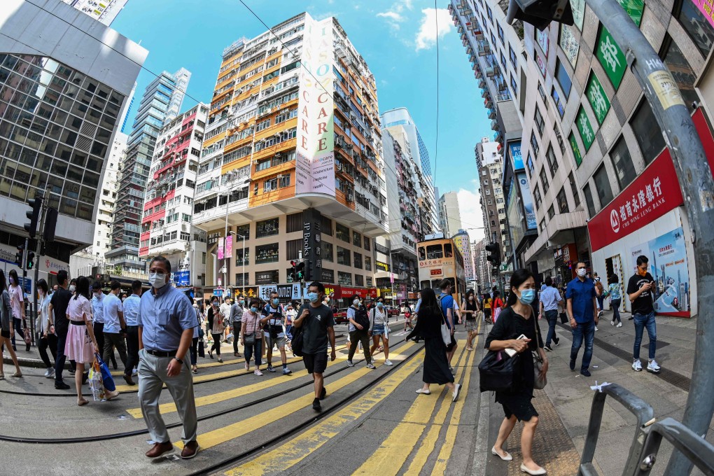 Pedestrians crossing a road in Wan Chai on October 5, 2021. Photo: AFP