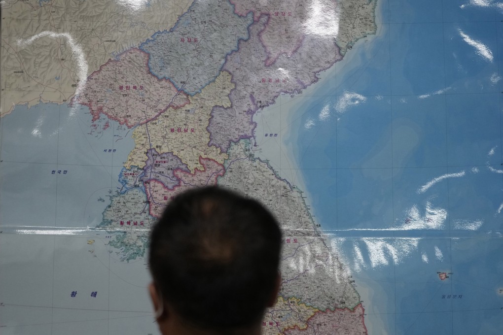 A Chinese-North Korean refugee who wished to be identified only as Yoon pictured in front of a map of the Korean peninsula. Photo: AP