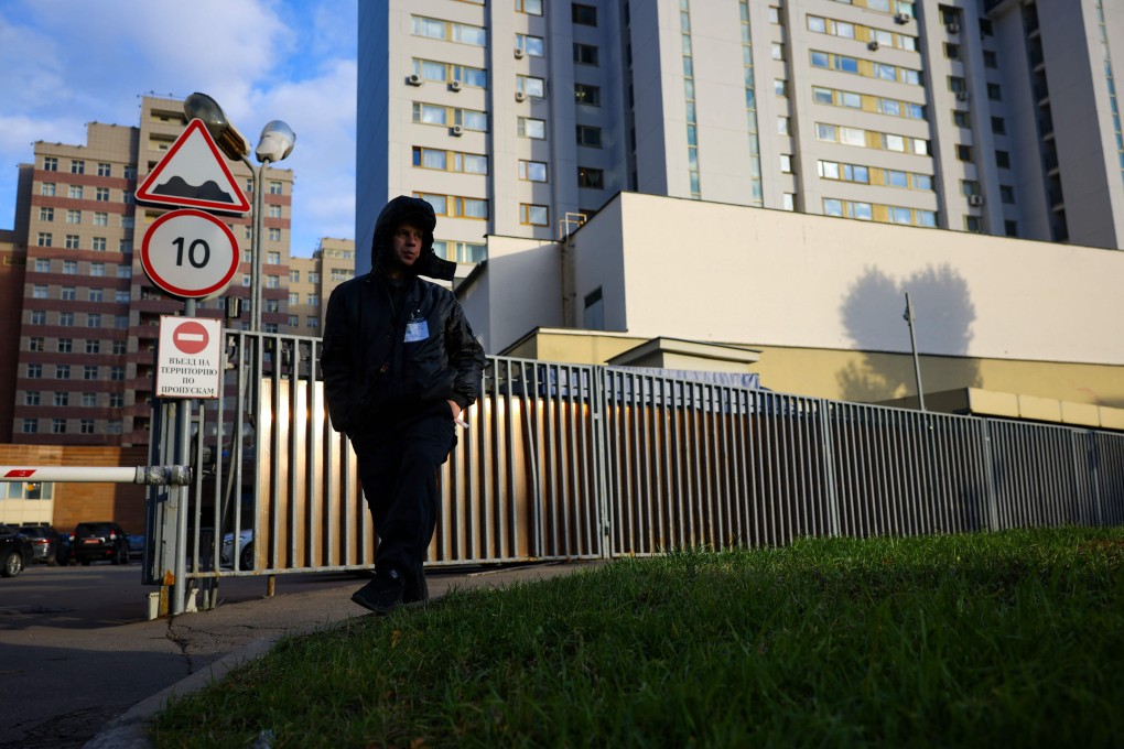 A security guard patrols outside a building that houses the Nato information office in Moscow on Monday. Photo: AFP