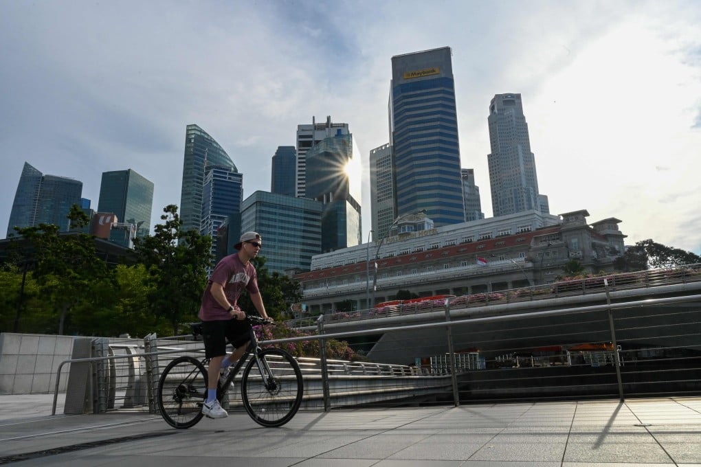 A man cycles past the city skyline in Singapore on Wednesday. Photo: AFP