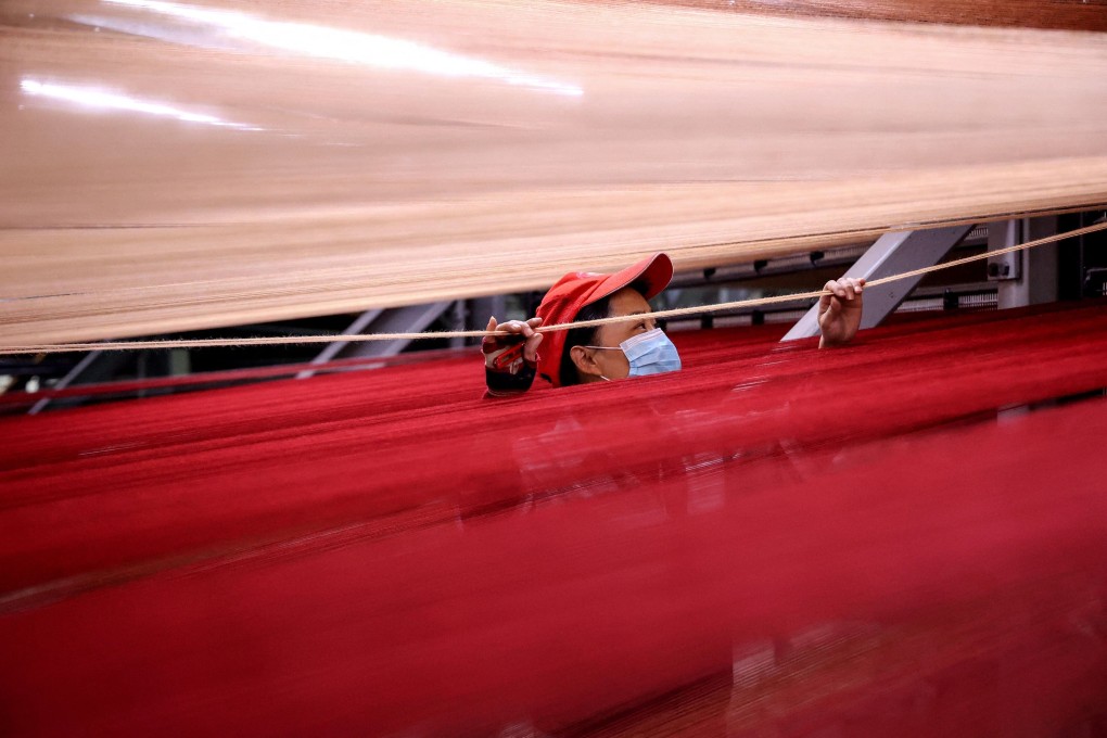 A worker produces carpets for export at a factory in Binzhou in China's eastern Shandong province. Photo: AFP/China OUT