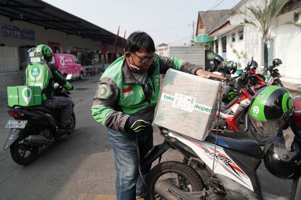 A Gojek driver picks up a Tokopedia order at a fulfilment centre in Jakarta, Indonesia, in May. Photo: Bloomberg