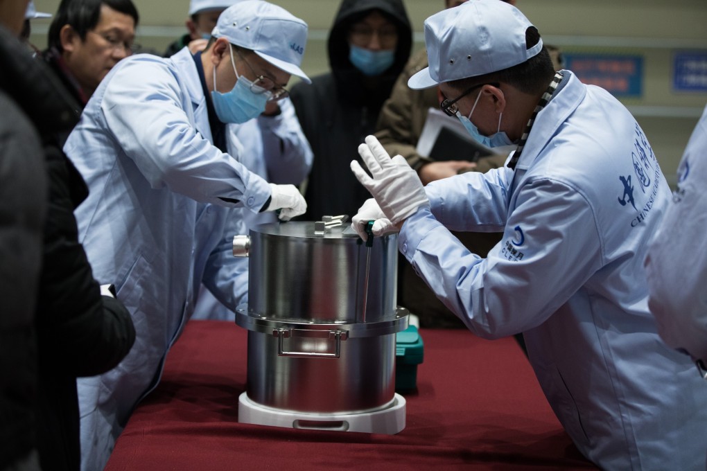 Scientists in Beijing with the container of lunar samples collected by the Chang’e 5 probe in December. Photo: Xinhua
