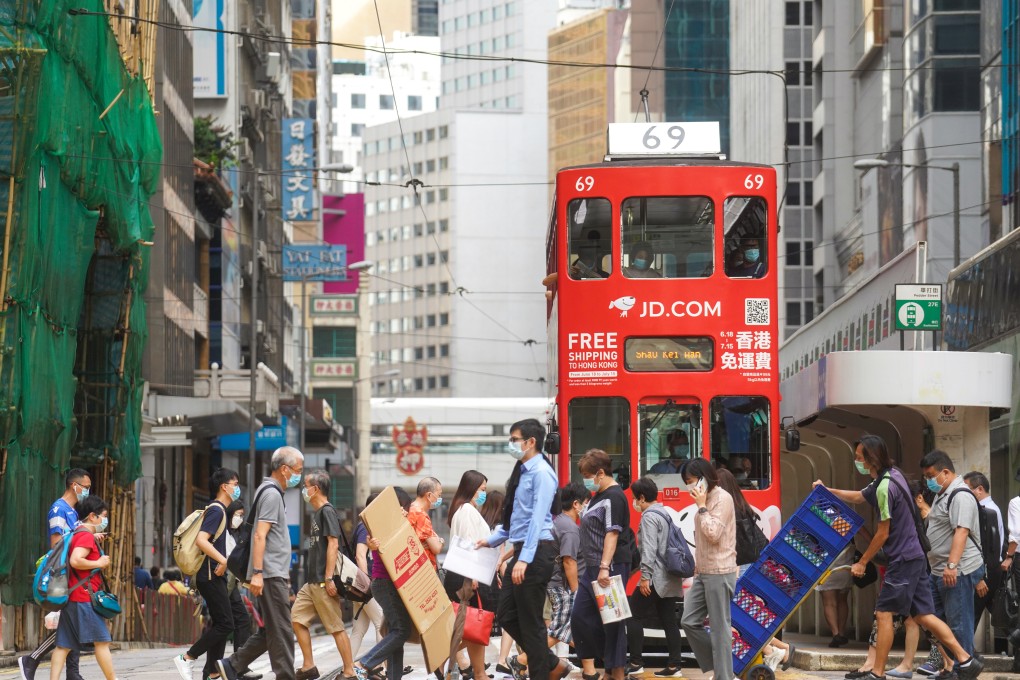 Pedestrians cross a road in Central, Hong Kong. China on Wednesday auctioned 6 billion yuan of sovereign bonds in the city to help deepen the local debt market. Photo: Winson Wong