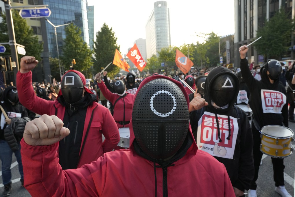 Members of the South Korean Confederation of Trade Unions wear masks and costumes inspired by the Netflix hit as they attend a rally in Seoul demanding job security. Photo: AP