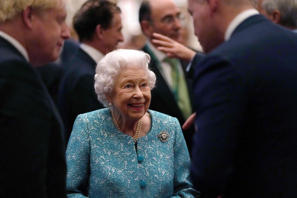 Britain’s Queen Elizabeth and Prime Minister Boris Johnson (left) greet guests during a reception to mark the Global Investment Summit at Windsor Castle on Tuesday. Photo: AFP