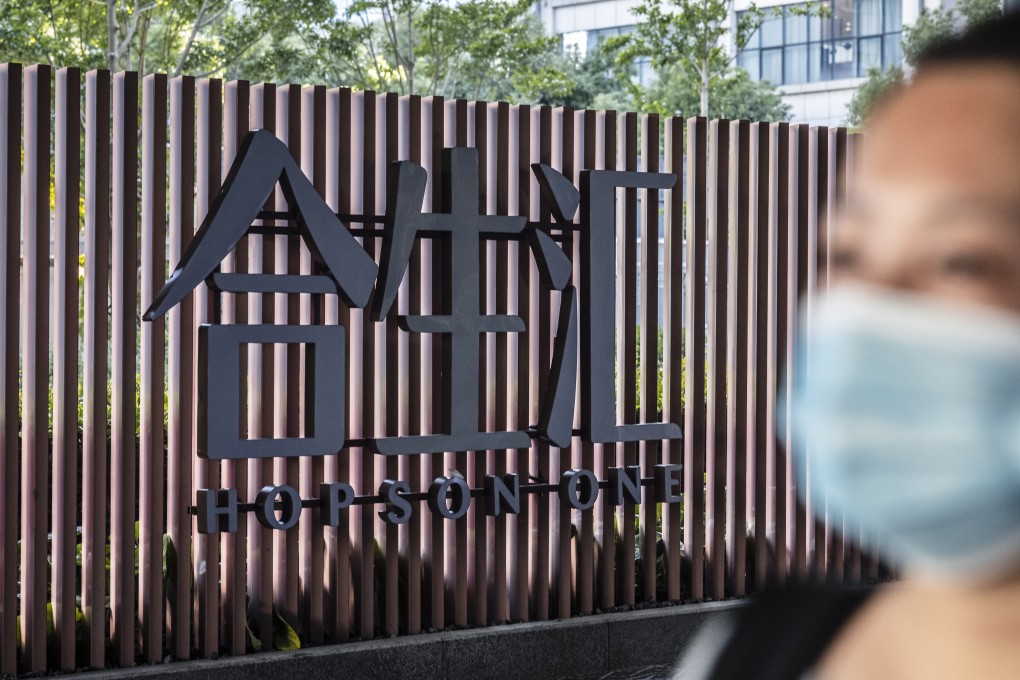 A woman walks in front of the Hopson compound in Shanghai, China, 05 October 2021. Photo: EPA-EFE