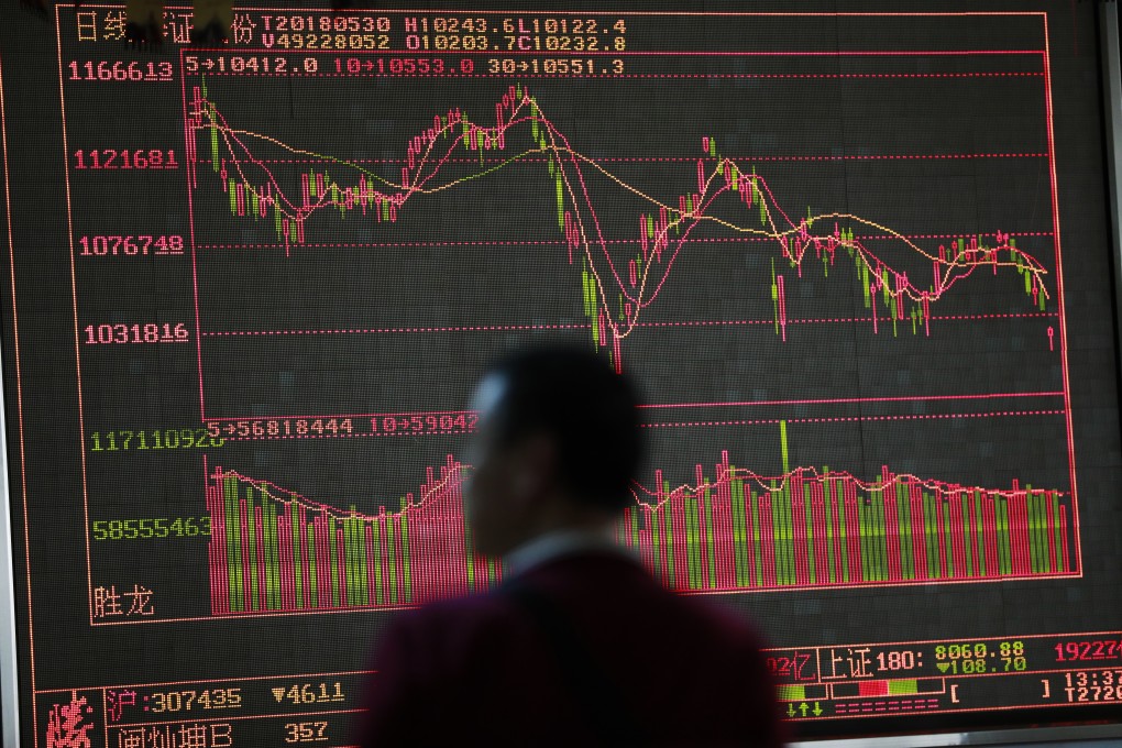 A man looks at an electronic board showing the stock index and prices at a securities brokerage in Beijing. China says it won’t stimulate the property market to shore up economic growth. Photo: EPA-EFE
