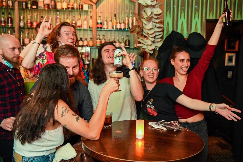 People celebrate in a bar in Melbourne on Friday. Photo: AFP
