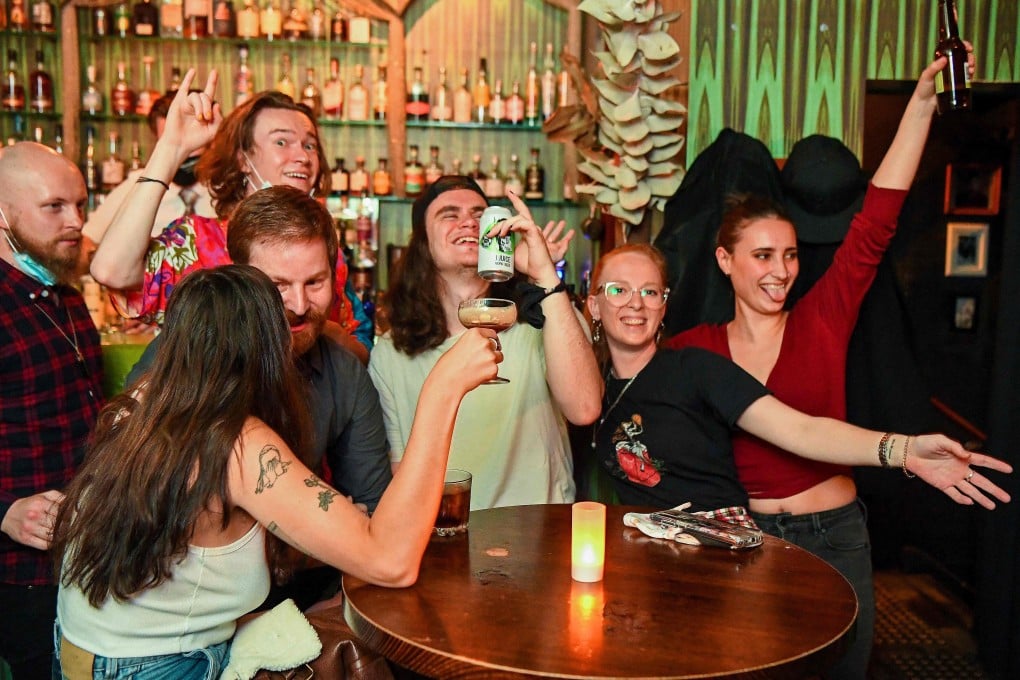 People celebrate in a bar in Melbourne on Friday. Photo: AFP