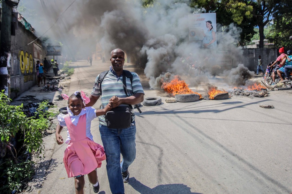 Tyres were set on fire by groups of motorcycle taxi drivers in Port-au-Prince on Thursday to protest against fuel shortages. Photo: AFP