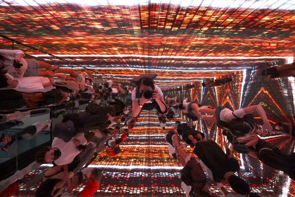Visitors enjoy an immersive art room experience of the NFT Collection, displayed during the first edition of the Digital Art Fair Asia 2021 in Central, in Hong Kong, in October. Photo: Nora Tam