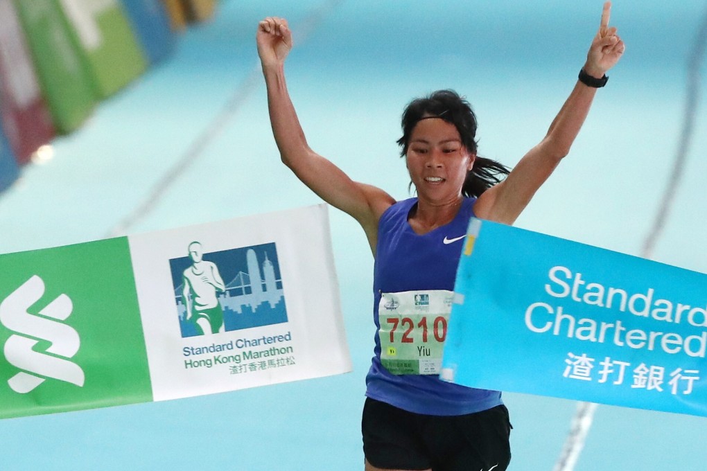 Christy Yiu Kit-ching celebrates at the finish line at Victoria Park in Causeway Bay after winning the half marathon at the 2019 Standard Chartered Hong Kong Marathon. Photo: Nora Tam