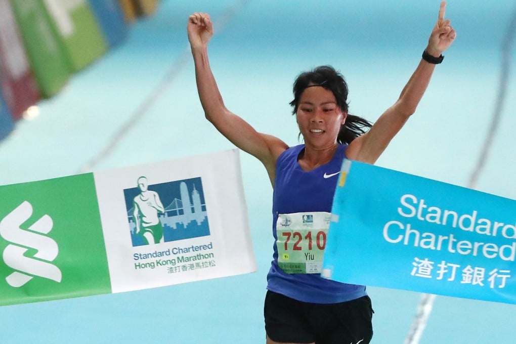 Christy Yiu Kit-ching celebrates at the finish line at Victoria Park in Causeway Bay after winning the half marathon at the 2019 Standard Chartered Hong Kong Marathon. Photo: Nora Tam
