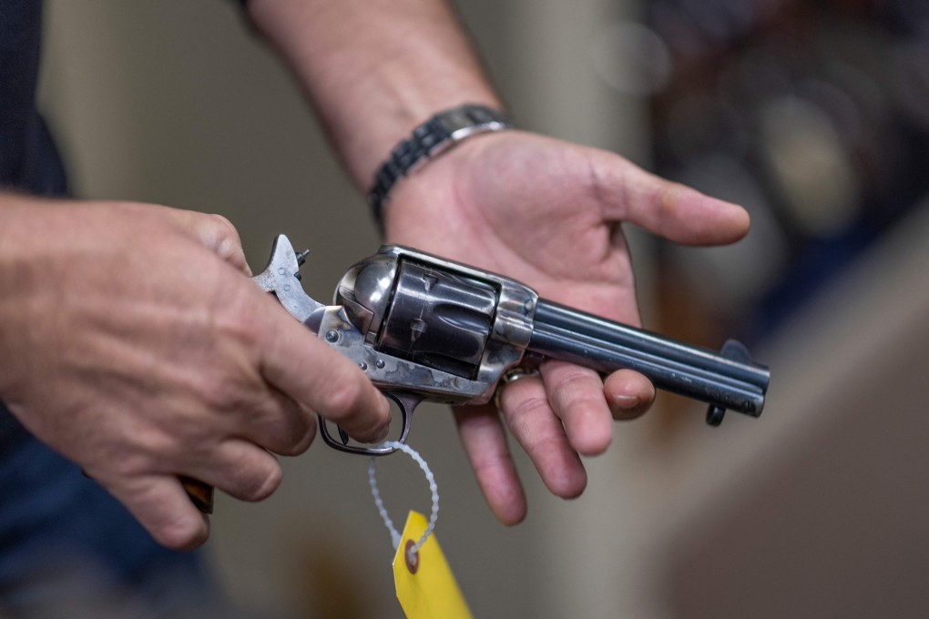 Props expert Guillaume Delouche holds a prop gun while talking about them in Sunland-Tujunga, Los Angeles, on Friday. Photo: AFP