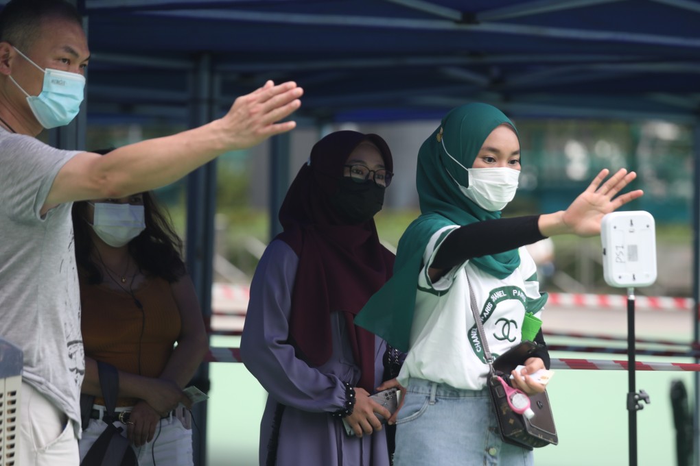 Hong Kong domestic workers queue for Covid-19 testing at Victoria Park earlier in the year. Photo: Xiaomei Chen