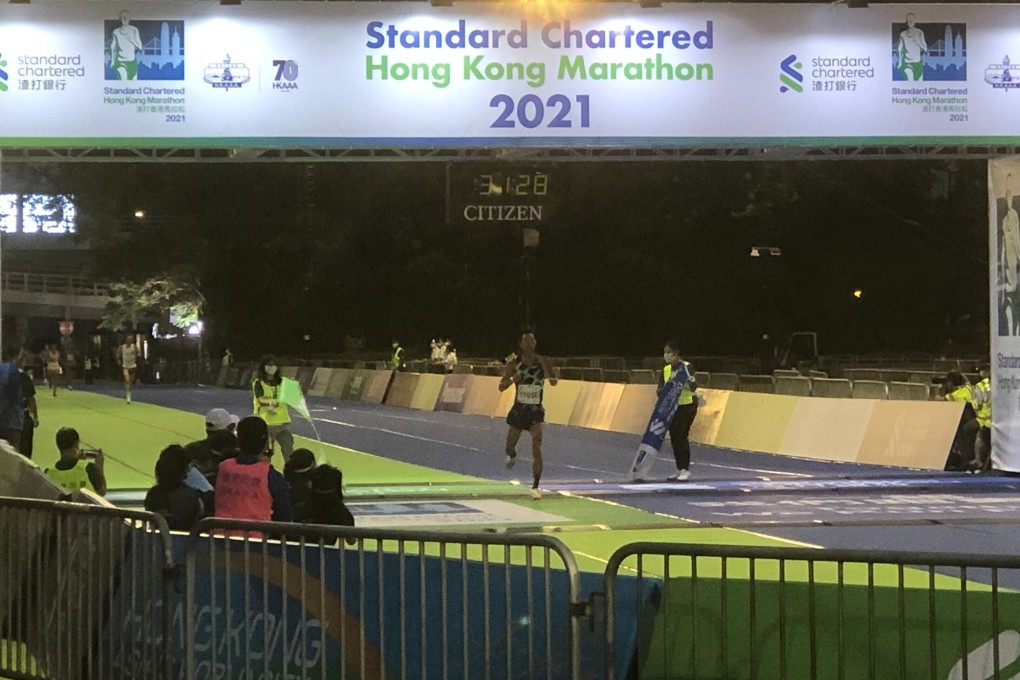 Hong Kong triathlete Wong Tsz-to crosses the line at Victoria Park after winning the men's 10km at the 2021 Standard Chartered Hong Kong Marathon. Photo: Jonathan White