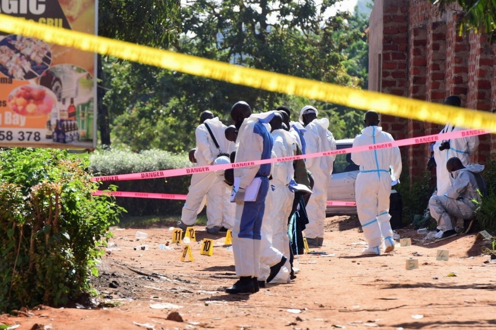 Ugandan explosives experts secure the scene of an explosion in Komamboga, a suburb on the northern outskirts of Kampala, on Sunday. Photo: Reuters