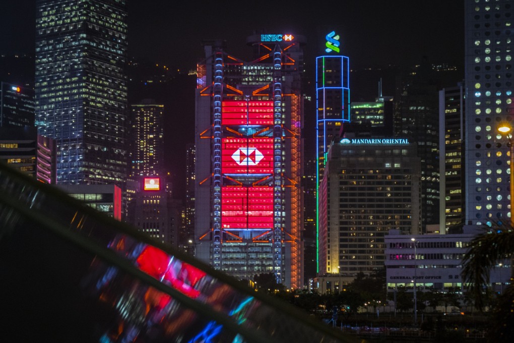 The HSBC and Standard Chartered buildings are illuminated in Hong Kong. HSBC kicks of the third-quarter earnings season on Monday. Photo: Bloomberg