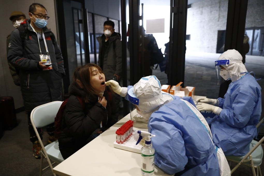 A member of the media is tested for the Covid-19 at an Olympic test event in China. Photo: Reuters