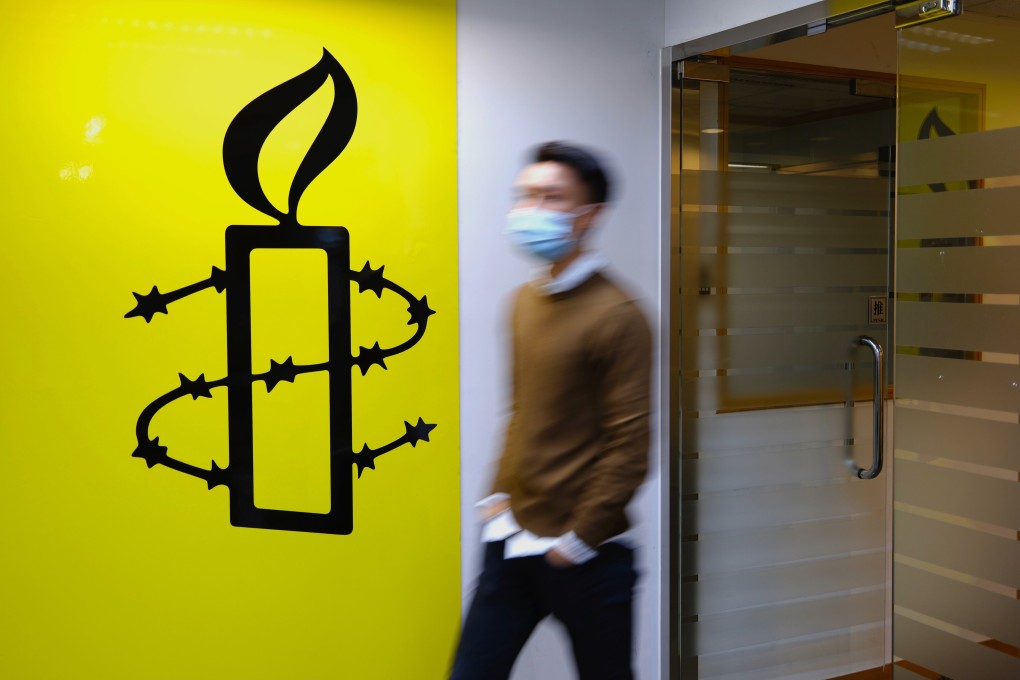 A man walks past one of two Amnesty International offices in Hong Kong. The group announced on Monday that both premises would be closed by year’s end. Photo: AP