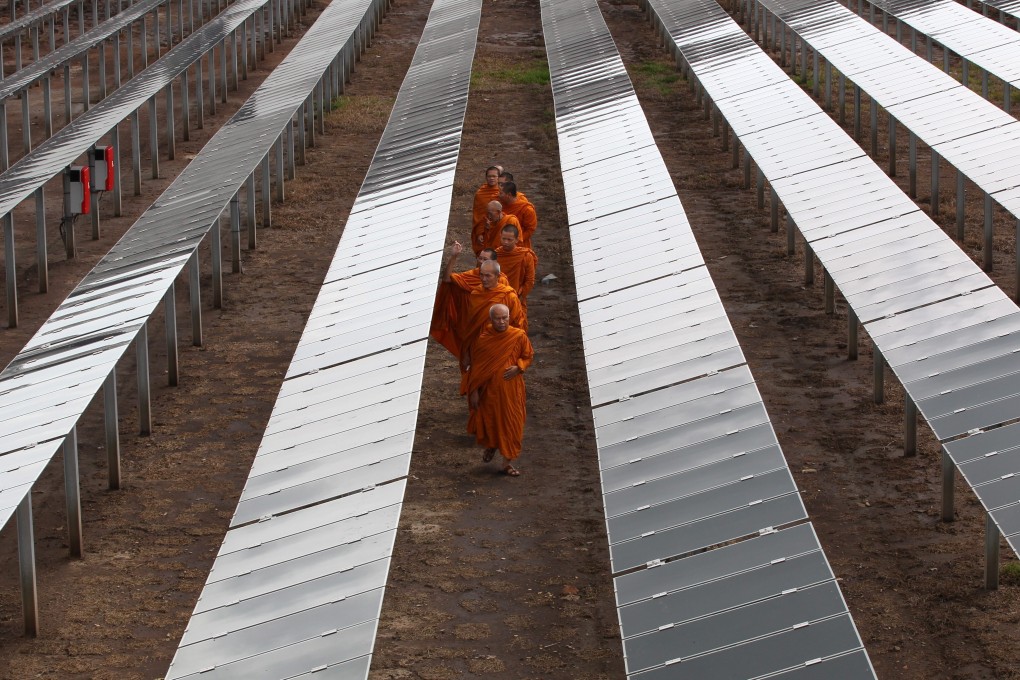 Thai Buddhist monks at a solar power plant about 60km from Bangkok, Thailand. Photo: EPA