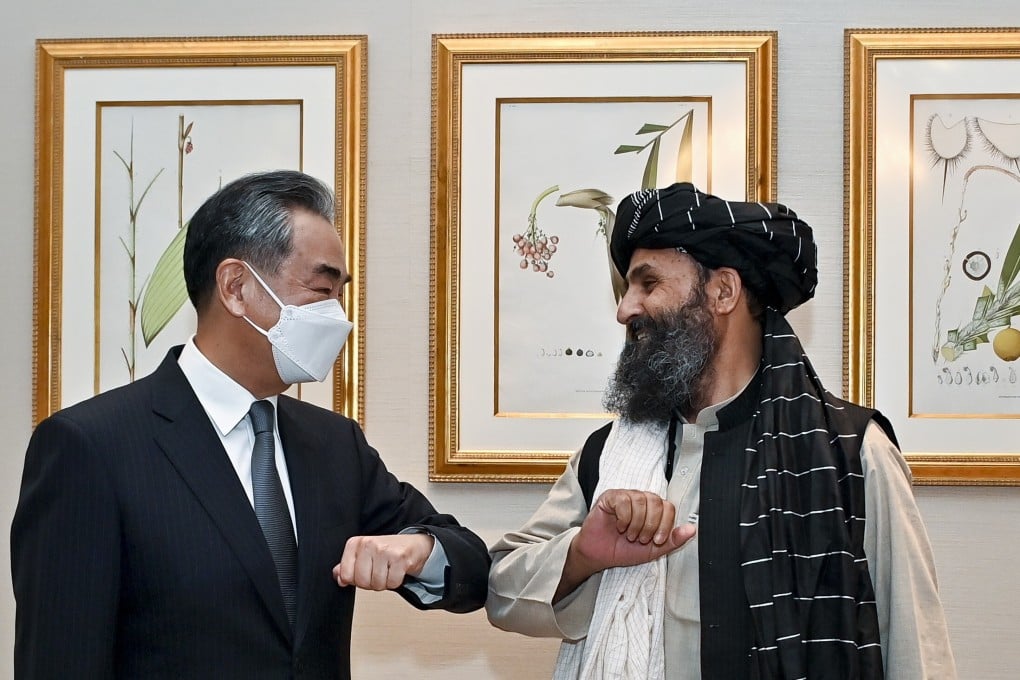 Chinese Foreign Minister Wang Yi with Mullah Abdul Ghani Baradar in Doha, Qatar, on Monday. Photo: EPA-EFE