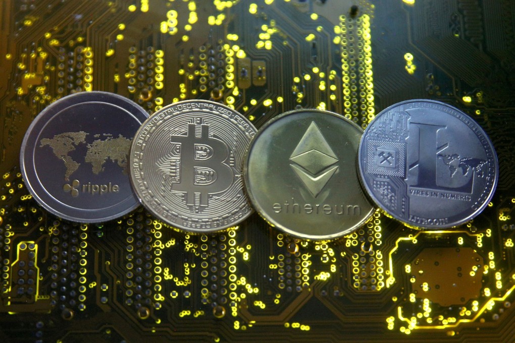 Representations of the Ripple, bitcoin, ether and Litecoin virtual currencies seen on a PC motherboard on February 14, 2018. Photo: Reuters
