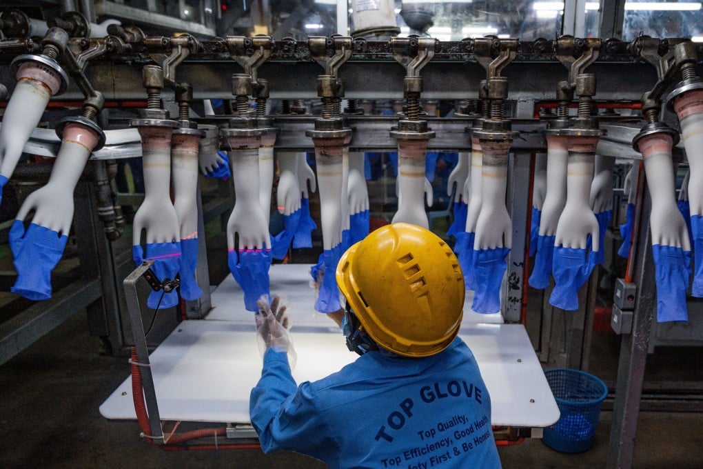 A worker inspecting disposable gloves at Top Glove’s factory in Shah Alam near Kuala Lumpur on August 26, 2020. Photo: AFP