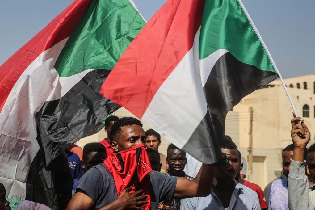 Sudanese protesters waving the national flag demonstrate in the capital Khartoum on Monday. Photo: EPA-EFE
