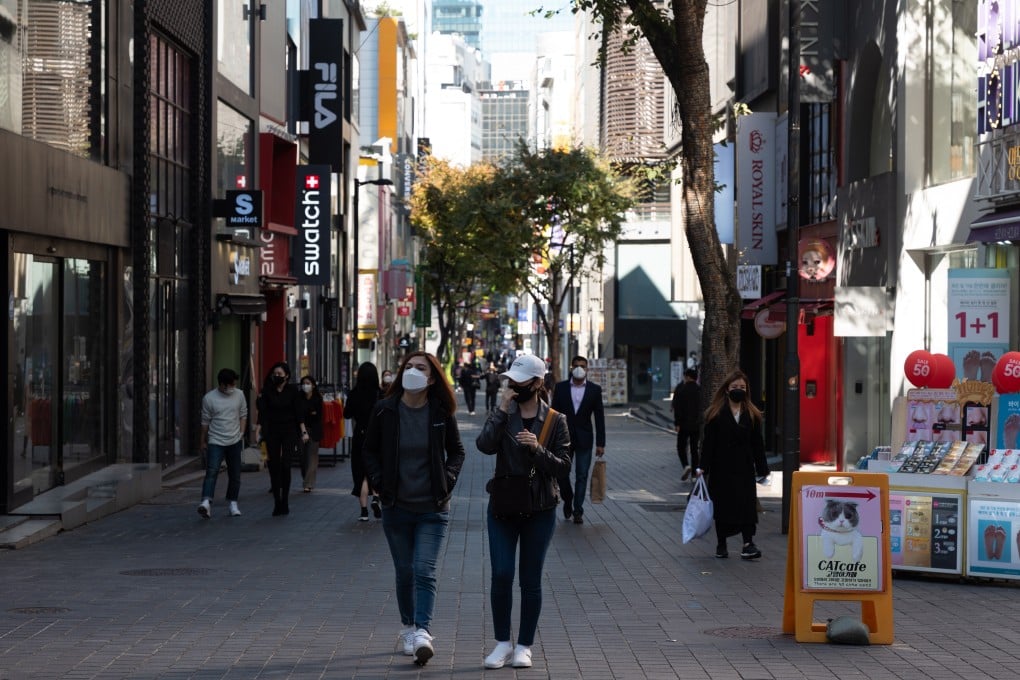 South Koreans walk in Myeong-dong street in Seoul, after the government announced it would gradually phase out its Covid-19 restrictions, starting on November 1. Photo: EPA-EFE